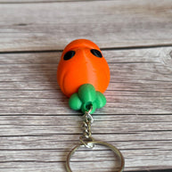 Top of a 3D printed carrot-shaped keychain on a wooden surface