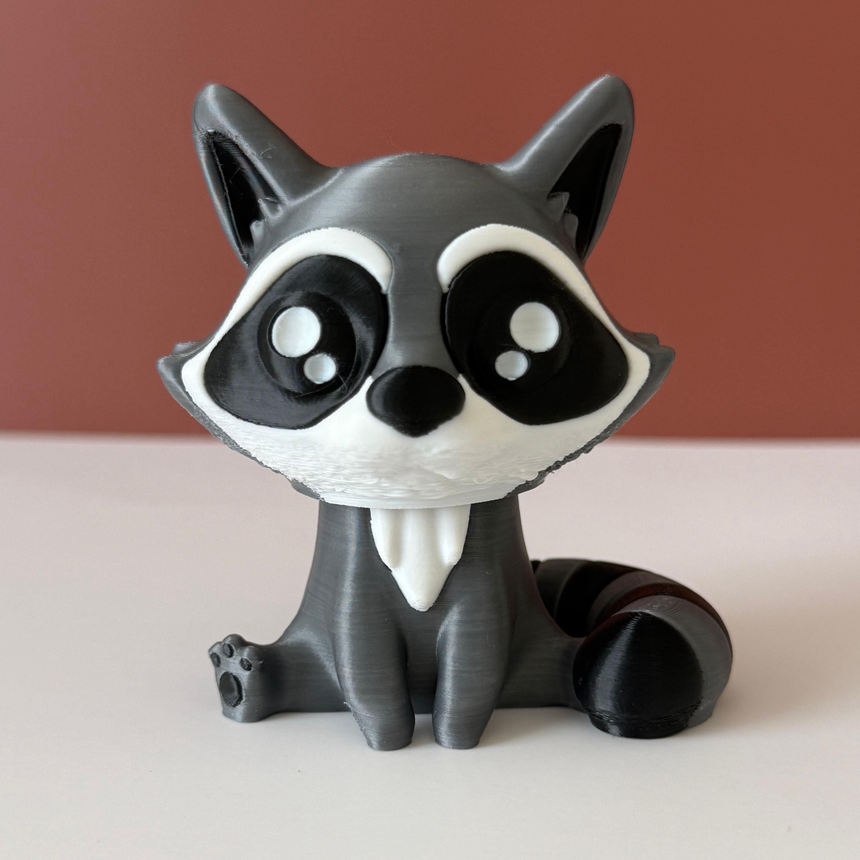 Toy raccoon figure on a white surface