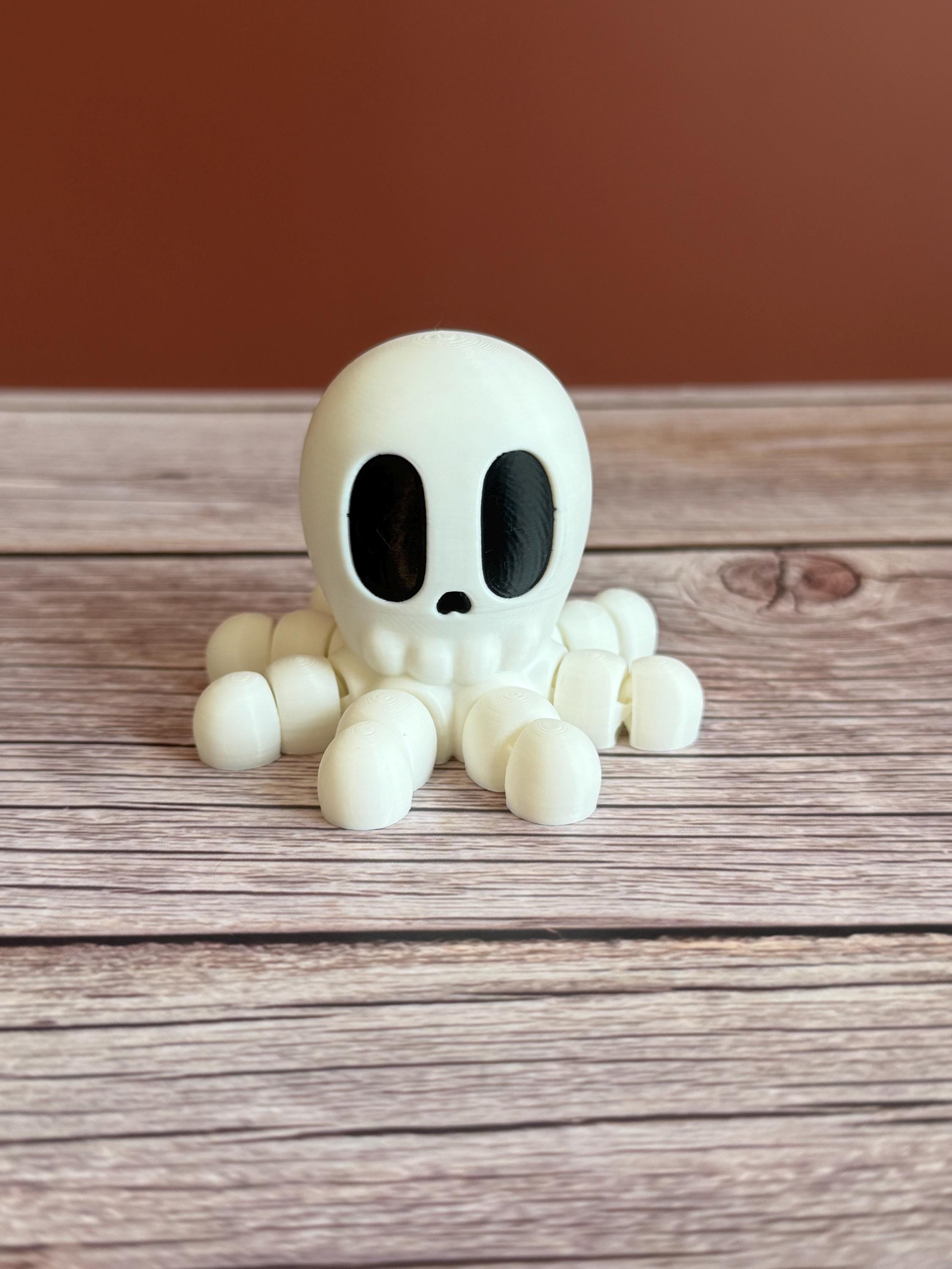 White 3D printed skeleton-like octopus placed on a wooden surface