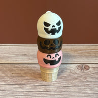Pink, White, and Brown 3D printed ice cream cone keychain with smiling, mischievous, and goofy expressions on the ice cream scoops.