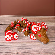 A 12-inch articulated 3D printed dragon with a design resembling a mushroom, with red and white caps on a wooden surface.