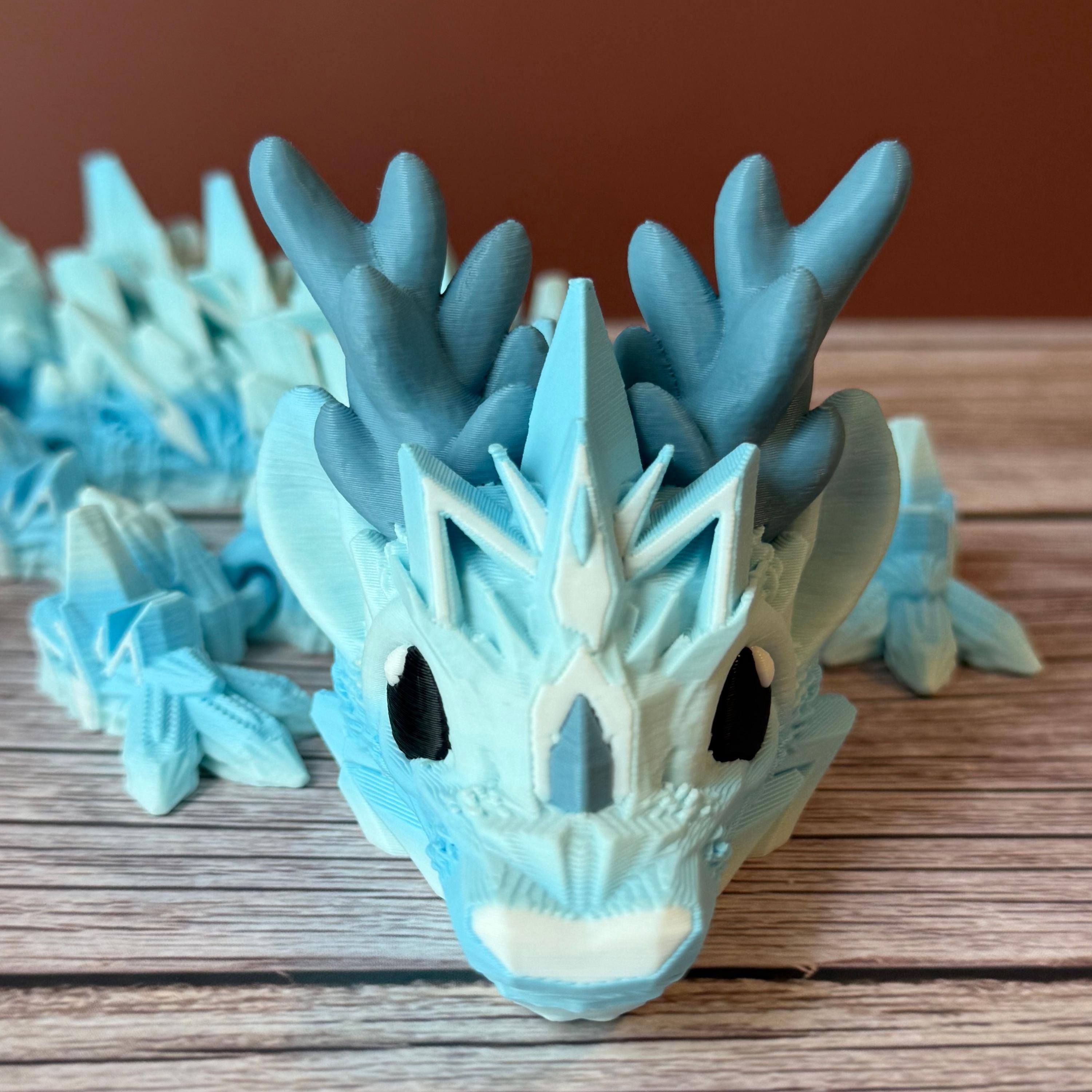 Blue dragon toy featuring a winter ice themed body, place on a wooden surface