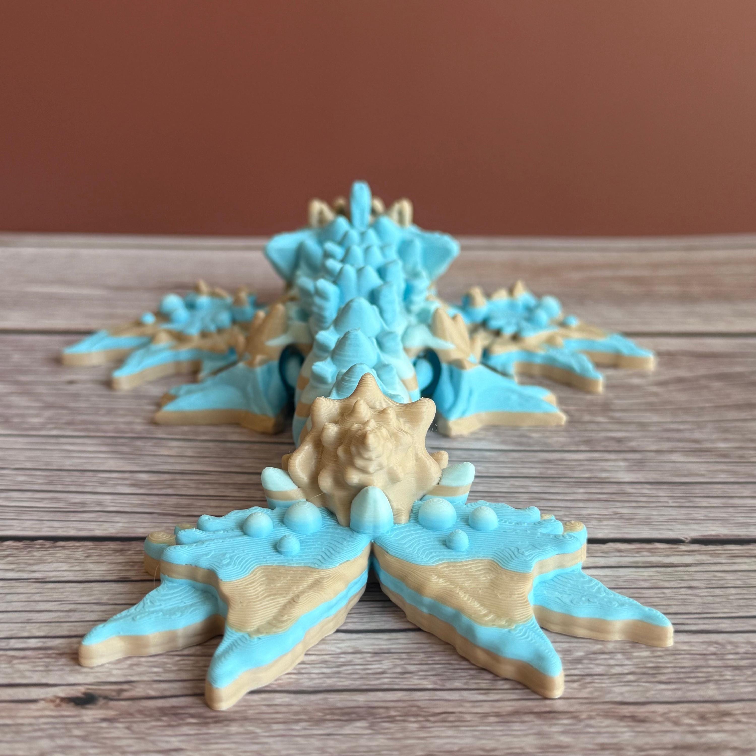Toy dragon ocean themed figurine with blue and beige colors sitting on a wooden surface