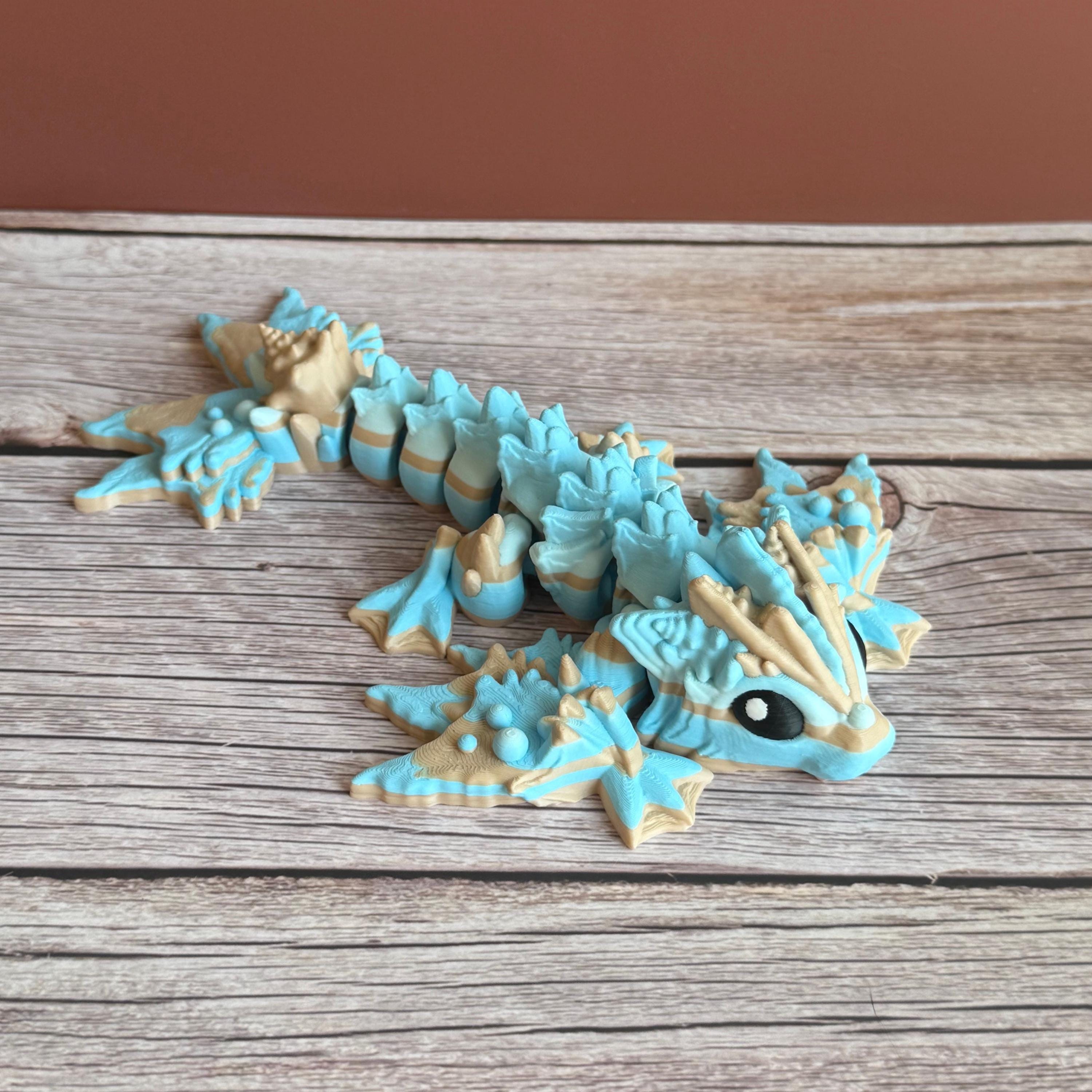 Toy dragon ocean themed figurine with blue and beige colors sitting on a wooden surface
