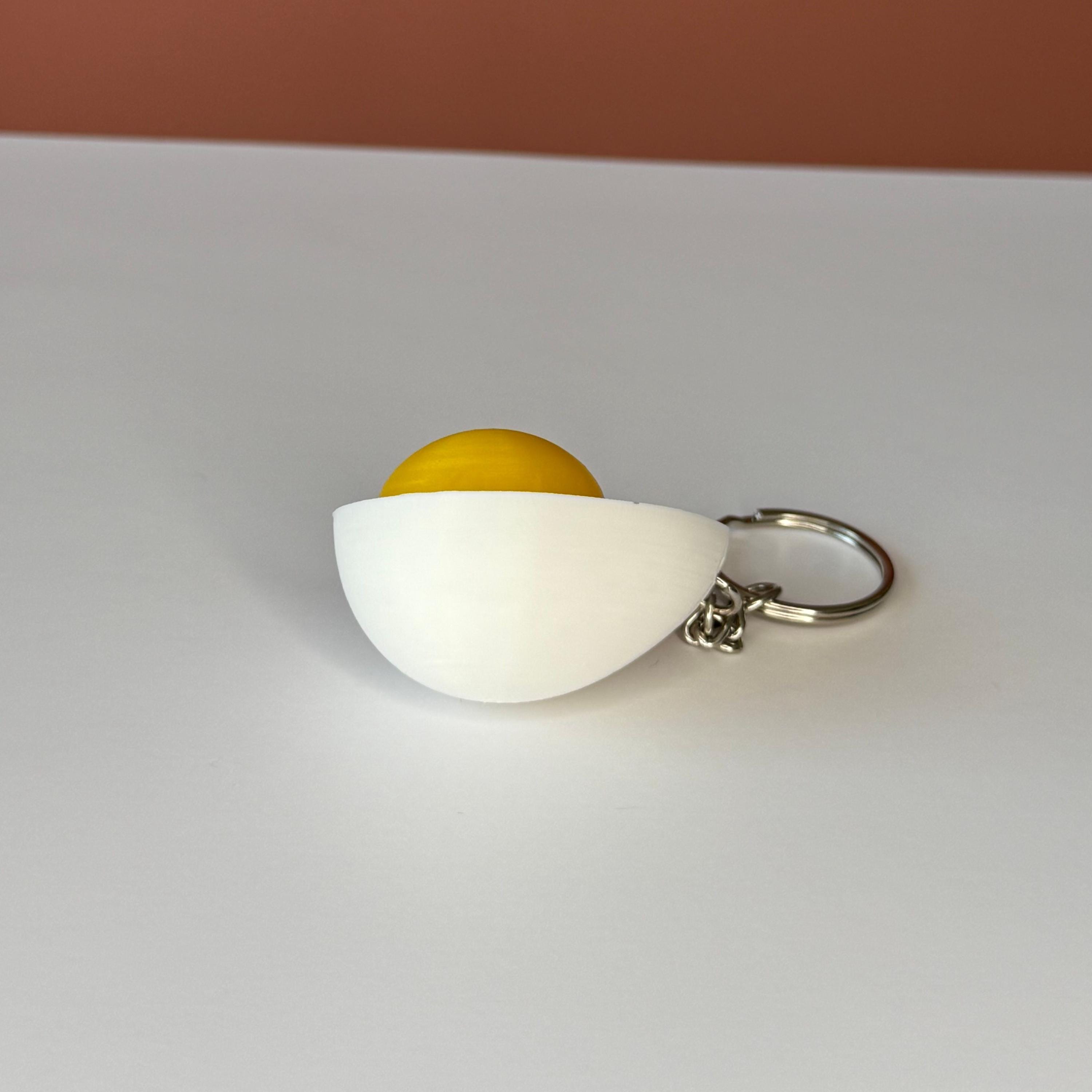 hard-boiled egg keychain with cartoonish design on a white background