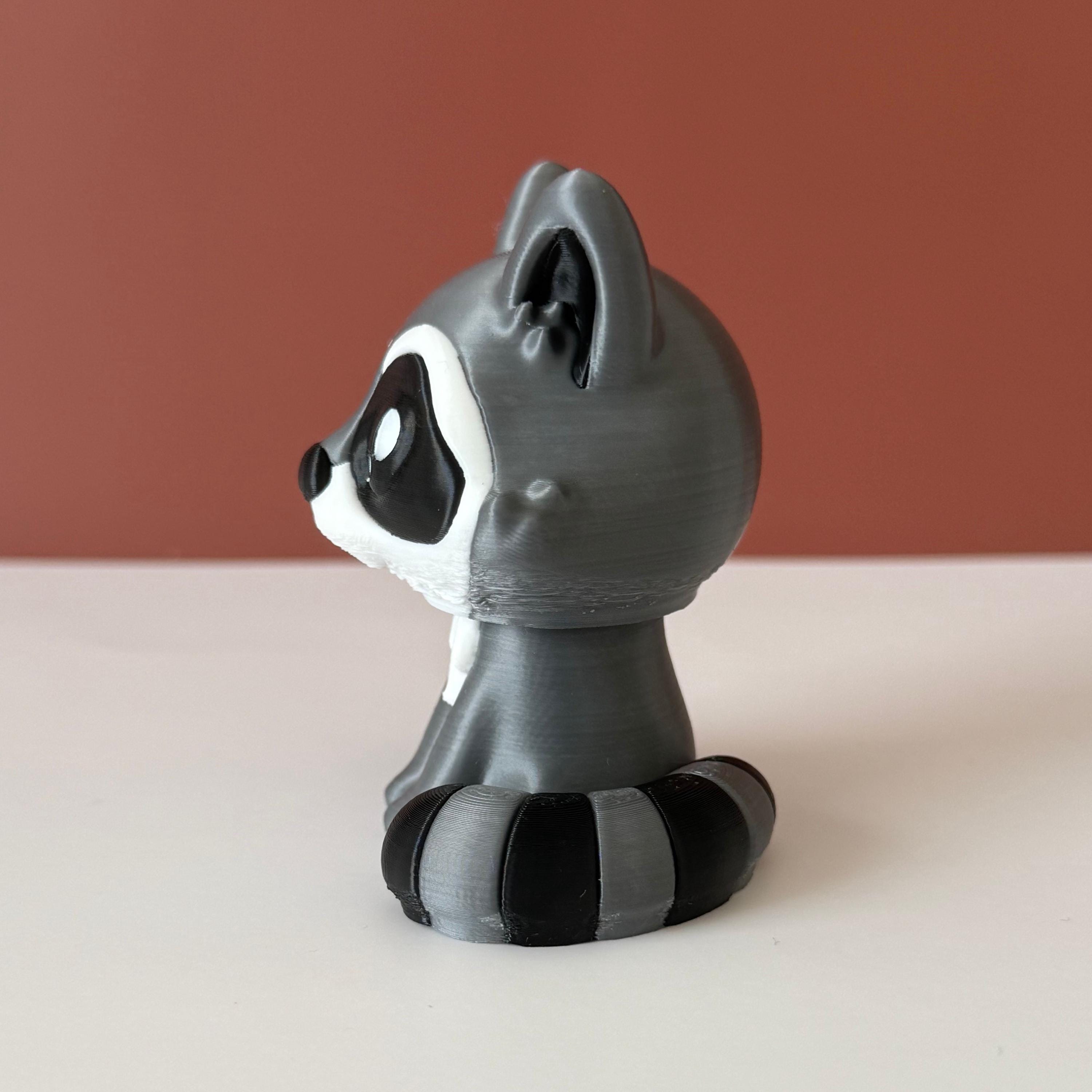 Toy raccoon figure on a white surface