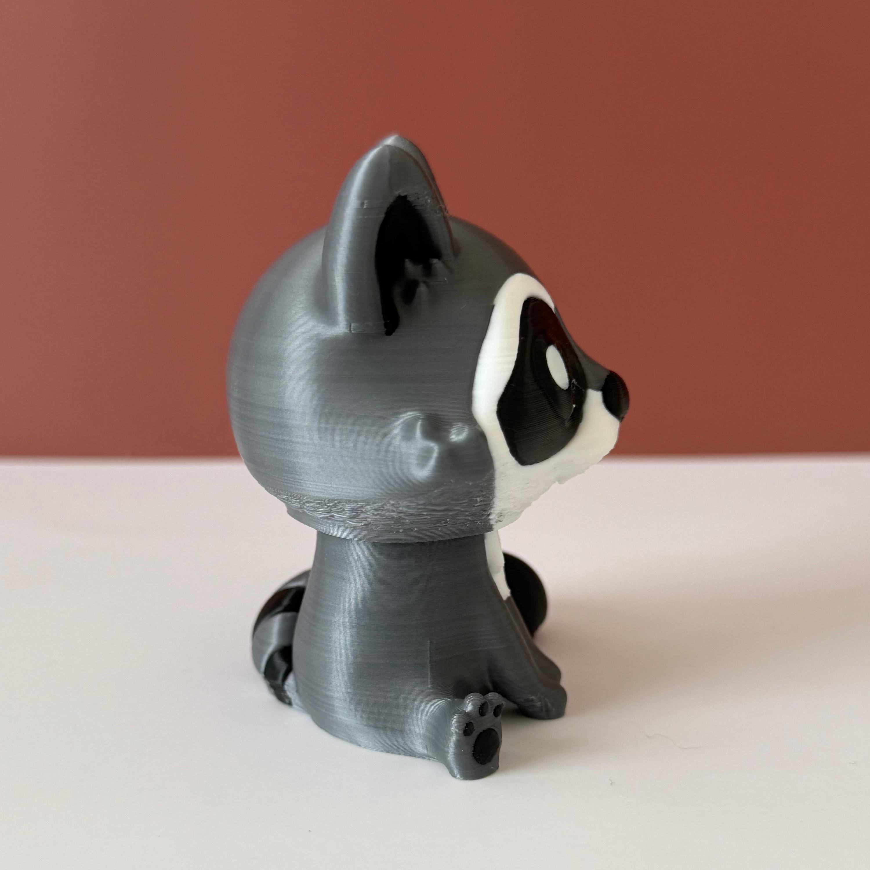 Toy raccoon figure on a white surface