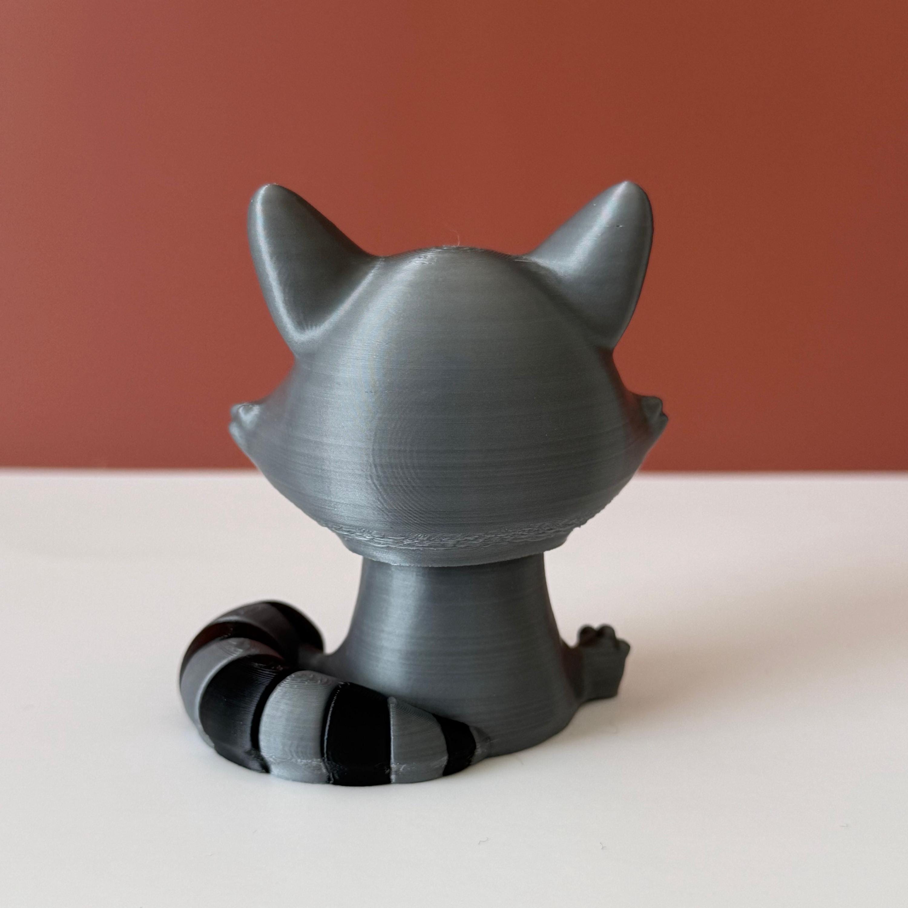 Toy raccoon figure on a white surface