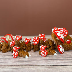 A 12-inch articulated 3D printed dragon with a design resembling a mushroom, with red and white caps on a wooden surface.