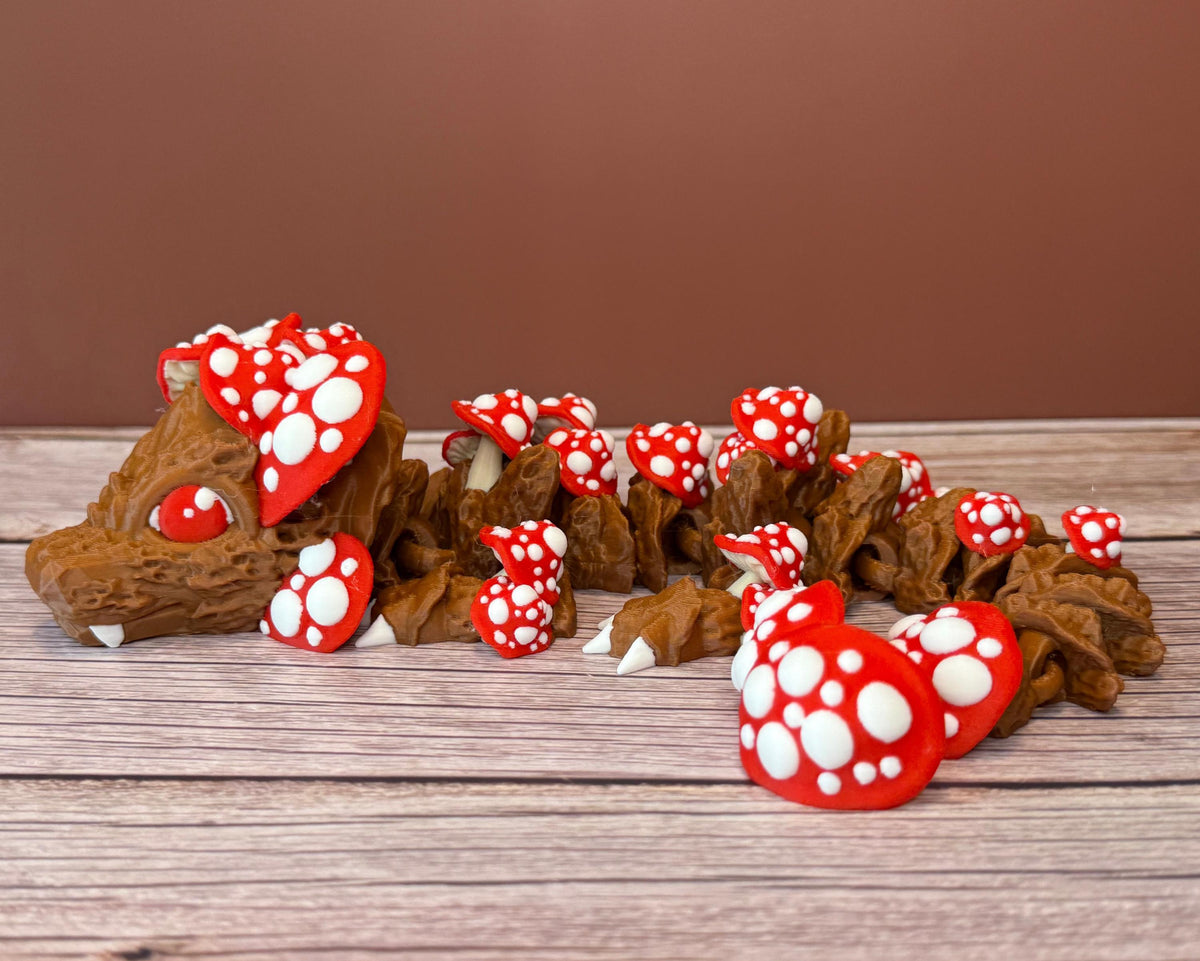 A 12-inch articulated 3D printed dragon with a design resembling a mushroom, with red and white caps on a wooden surface.