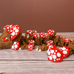 A 12-inch articulated 3D printed dragon with a design resembling a mushroom, with red and white caps on a wooden surface.