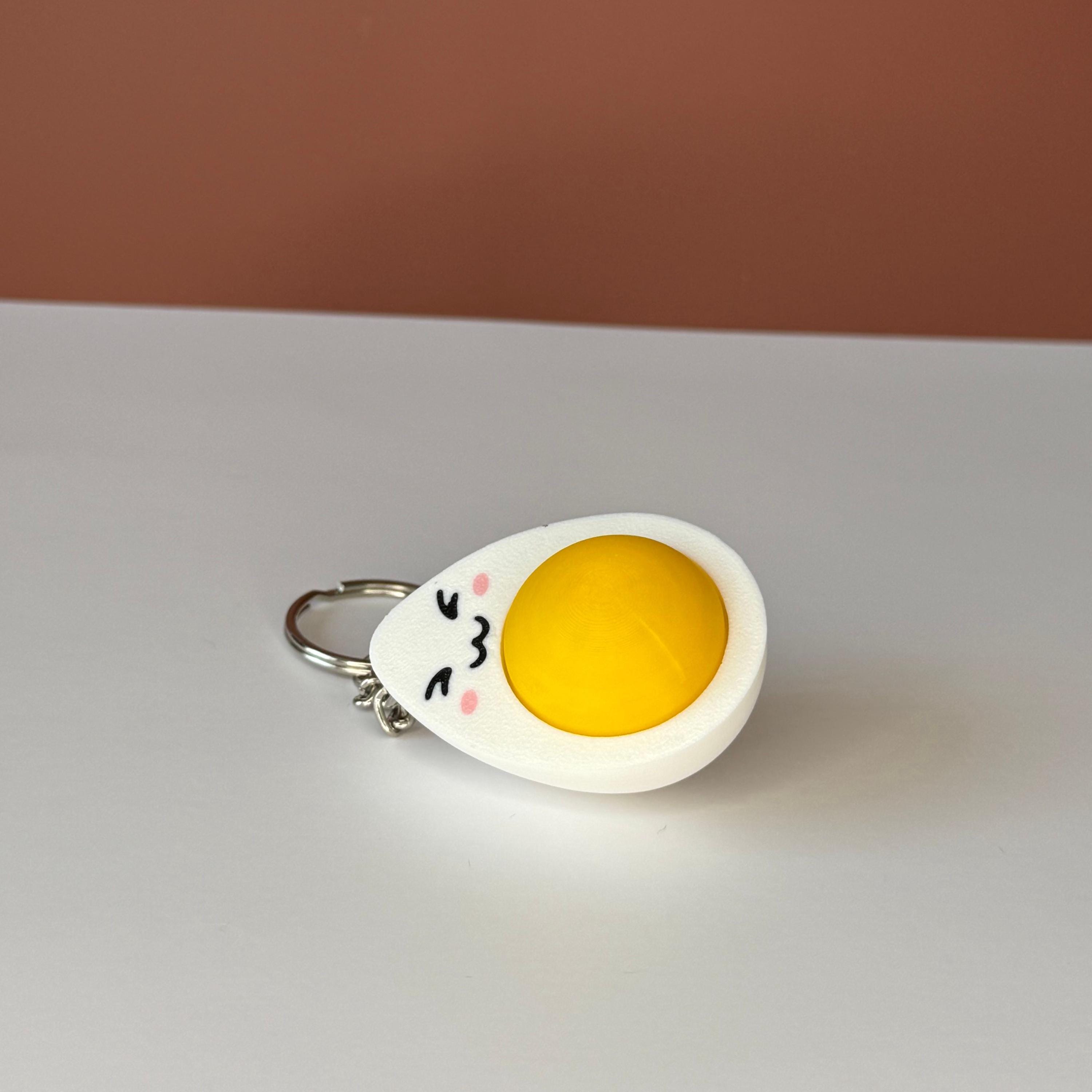 hard-boiled egg keychain with cartoonish design on a white background