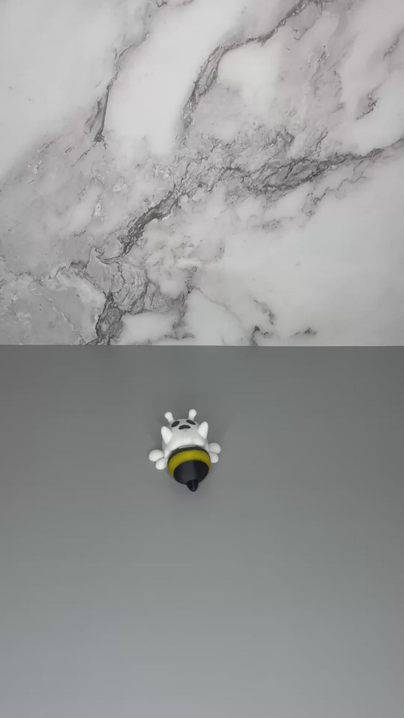 Ghost figure with white wings and a black and yellow bee-shaped lower body being shaken to demonstrate articulation.